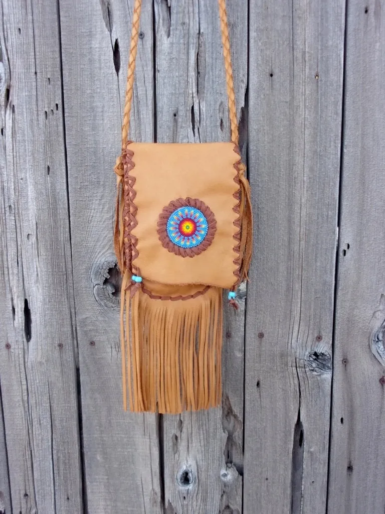 Fringed leather handbag with a beaded starburst rosette design , custom designed